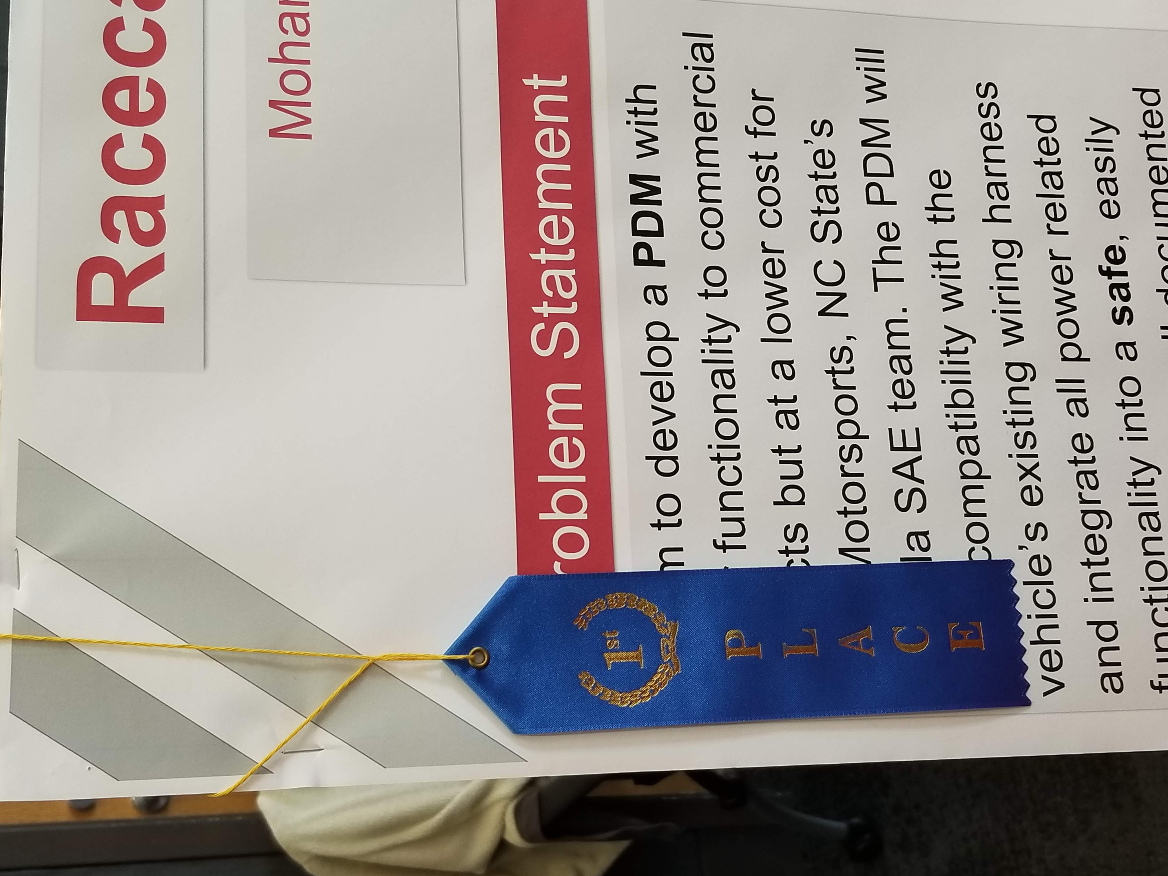 A picture of the 1st place ribbon hanging on one of our posters